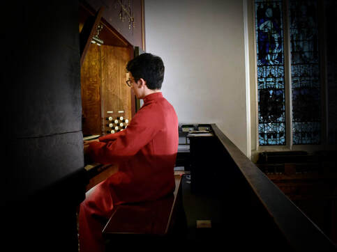 Organ scholar sitting at the organ